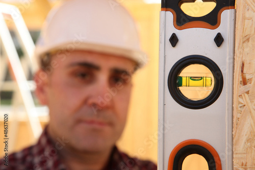 Photo: Builder with a spirit level Builder with a spirit level