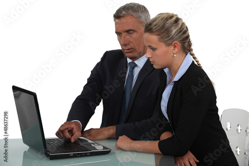 Photo: Businessman training his new assistant Businessman training his new assistant