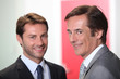 Two businessmen smiling