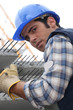 Construction worker with slabs of reinforced concrete