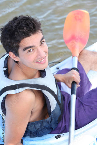Photo: Teenage boy in canoe Teenage boy in canoe