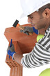 Mason chiseling brick