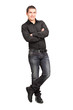 Full length portrait of a young male leaning against wall