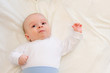 Cute newborn baby lying in bed