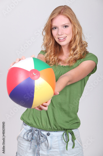 Photo: Teenage girl with inflatable beach ball Teenage girl with inflatable beach ball