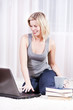 Beautiful blonde woman in her apartment over the internet.
