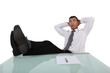 businessman having a break with legs on table