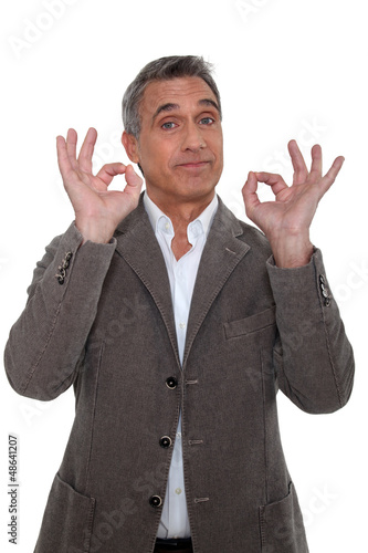 Photo: Senior businessman thinks everything is OK Senior businessman thinks everything is OK