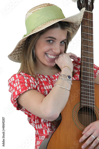 Photo: Playful girl holding guitar Playful girl holding guitar