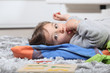 Photo: kid lying on the floor kid lying on the floor