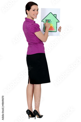 Photo: Woman with a house energy rating sign Woman with a house energy rating sign
