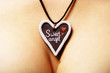 hand made pendant to St Valentine's day on breast's background