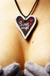 hand made pendant to St Valentine's day on breast's background