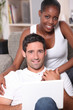 Couple sitting on sofa gray