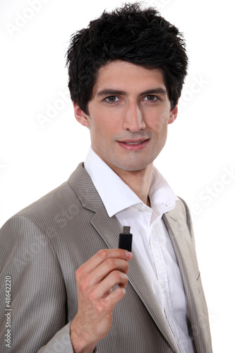 Photo: Businessman holding USB stick Businessman holding USB stick