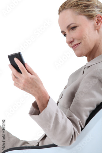 Photo: businesswoman on chair with laptop businesswoman on chair with laptop