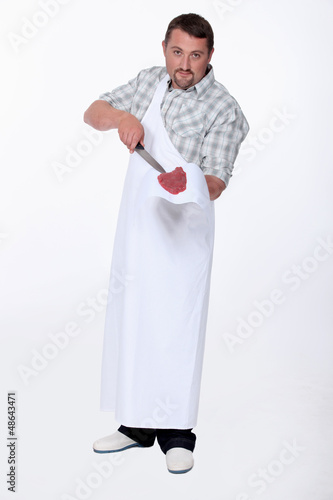 Photo: Butcher with knife and steak Butcher with knife and steak