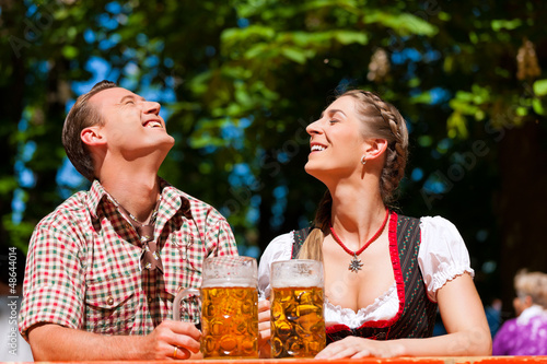 Photo: Happy Couple sitting in Beer garden Happy Couple sitting in Beer garden