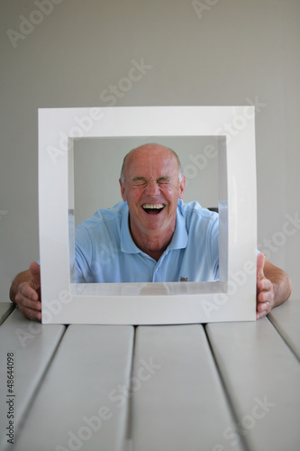Photo: senior looking through a picture frame senior looking through a picture frame