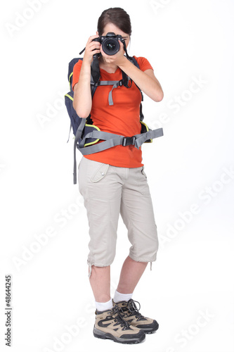 Photo: Girl with backpack taking photo Girl with backpack taking photo