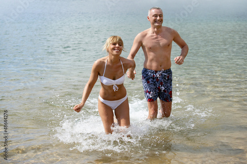 Photo: Couple running in the sea Couple running in the sea