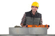 Stonemason using a bubble level