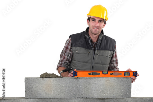Photo: Stonemason using a bubble level Stonemason using a bubble level