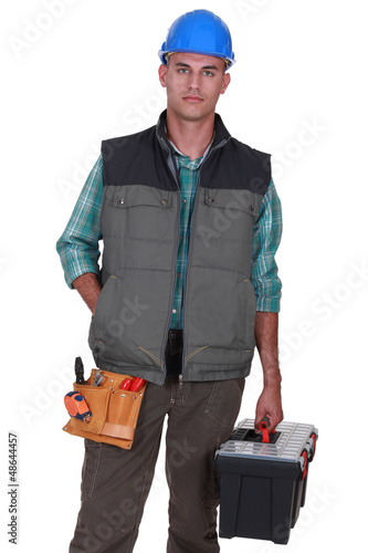 Photo: Bald worker holding tool box Bald worker holding tool box