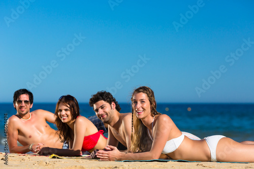 Photo: Friends on beach vacation in summer Friends on beach vacation in summer