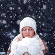 Photo: happy woman with closed eyes holding snow happy woman with closed eyes holding snow