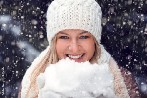 Photo: happy woman holding snow happy woman holding snow
