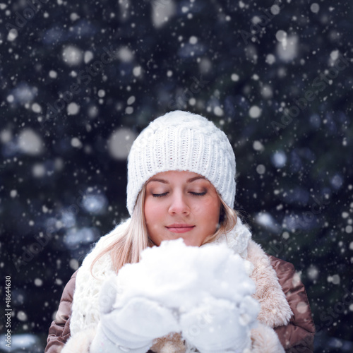 Photo: happy woman with closed eyes holding snow happy woman with closed eyes holding snow