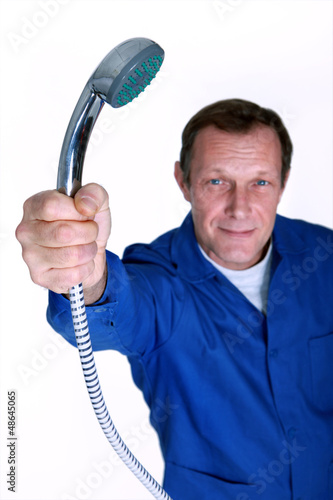 Photo: Plumber holding the shower head Plumber holding the shower head