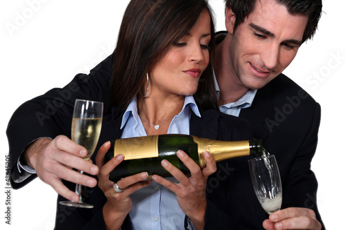 Photo: Couple celebrating with a glass of wine Couple celebrating with a glass of wine