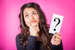 Photo: Doubtful Woman holding Question Mark Doubtful Woman holding Question Mark