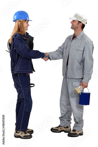 Photo: A painter and an electrician shaking hands. A painter and an electrician shaking hands.