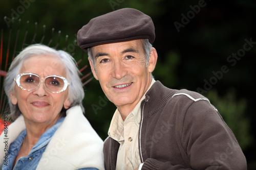 Photo: Elderly couple with garden rake Elderly couple with garden rake