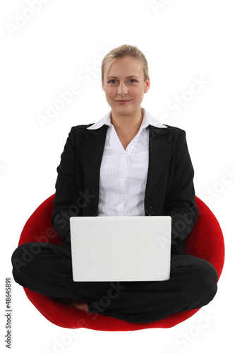 Photo: Businesswoman sat cross-legged Businesswoman sat cross-legged