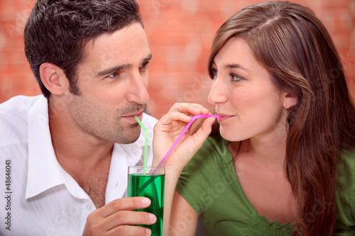 Photo: Couple sharing drink Couple sharing drink