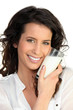 Photo: Cheerful woman holding milk Cheerful woman holding milk