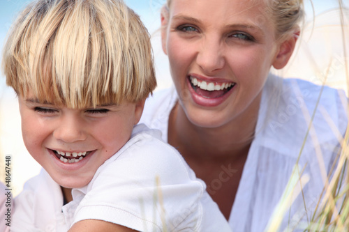 Photo: mother and son having fun outdoors mother and son having fun outdoors
