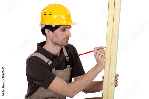 Photo: Carpenter marking wood Carpenter marking wood