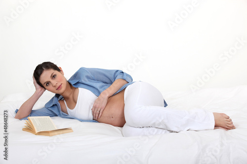 Photo: Pregnant woman reading a book Pregnant woman reading a book