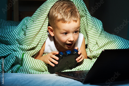 Photo: Playing videogames hiding in bed Playing videogames hiding in bed