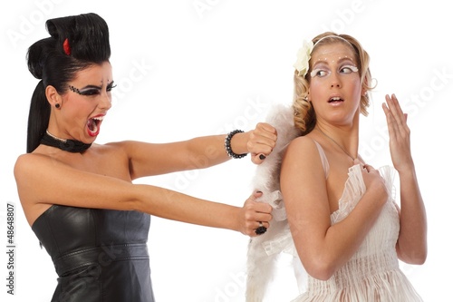 Photo: Devil tearing angel wings Devil tearing angel wings