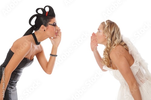 Photo: Devil and angel whispering Devil and angel whispering