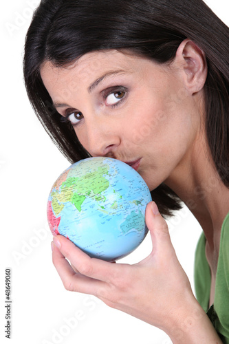 Photo: Woman kissing globe Woman kissing globe