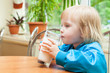 Little girl is drinking milk