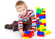 a funny boy is playing with lego