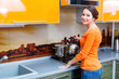 a young woman is putting a kettle